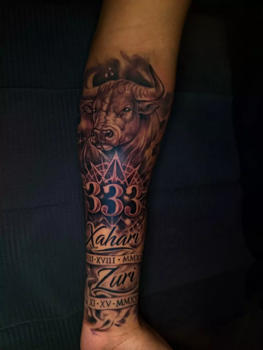 A forearm sleeve with a bull above two family names and dates in Roman numerals